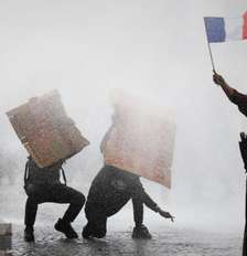 Manifestante mascarado segura bandeira francesa durante protestos de estudantes e confrontos com forças de ordem, em Paris, em 13 de outubro de 2026. Foto: REUTERS - Sarah Meyssonnier / RFI